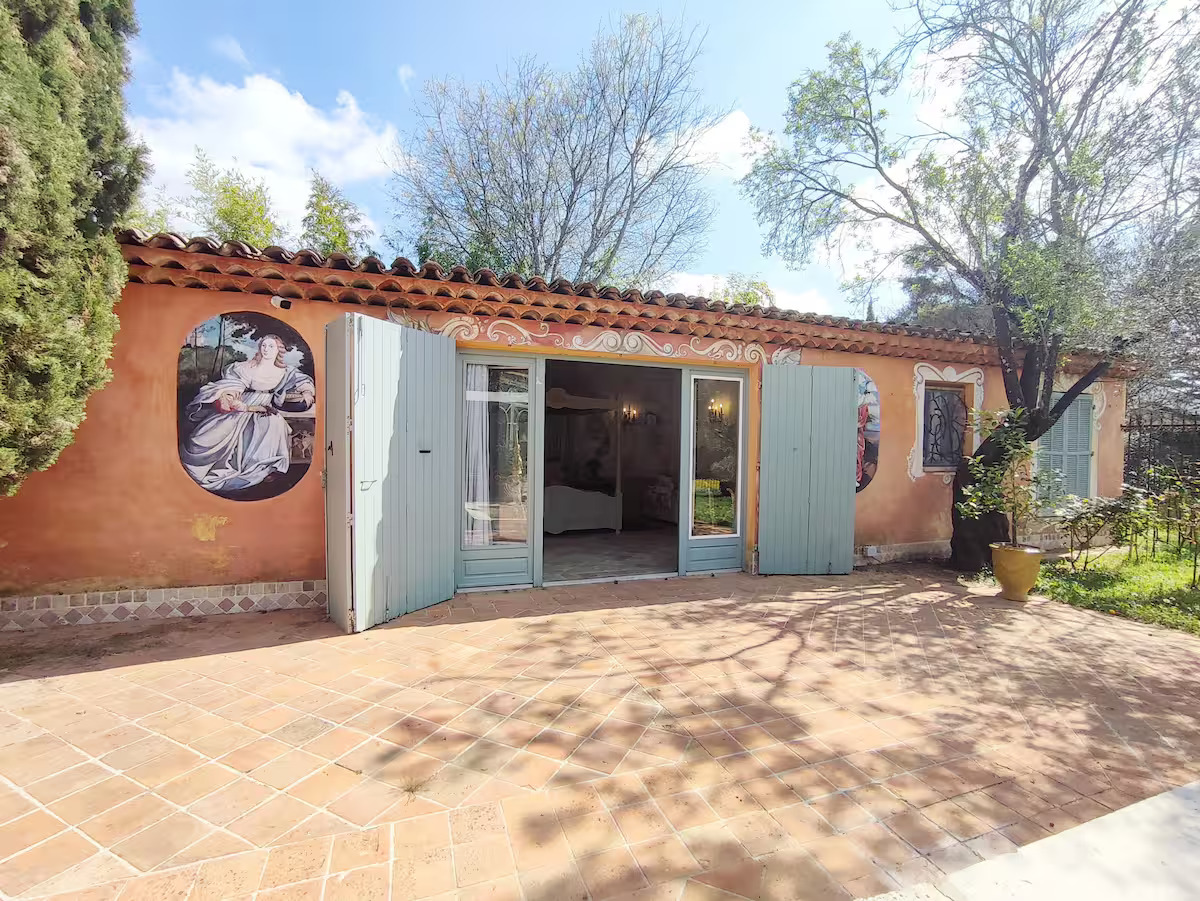 Charming rustic villa with colorful wall art.
