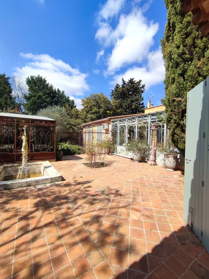 Sunny courtyard with trees and building